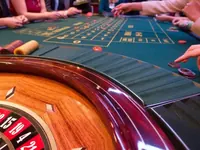 Roulette wheel beside the betting layout
