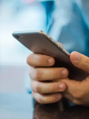 Hand holding an iPhone