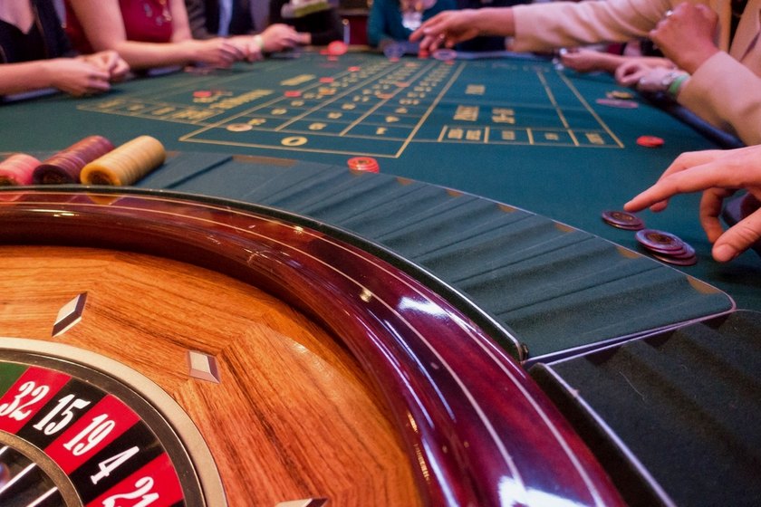 Roulette table in a casino: a player places a chip on the layout
